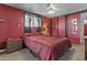 Bedroom with red walls, large bed, and a ceiling fan at 1707 S 72Nd St, Mesa, AZ 85209