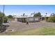 Home's backyard with desert landscaping, covered patio, and room for outdoor activities at 1707 S 72Nd St, Mesa, AZ 85209