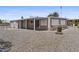 Back exterior of home with covered patio and gravel landscaping at 1707 S 72Nd St, Mesa, AZ 85209