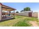 Green backyard space with grass, seating area, and a pool surrounded by a fence at 2003 W Tyson St, Chandler, AZ 85224