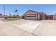 Home with an attached two-car garage and a paved driveway, set against a clear blue sky at 2003 W Tyson St, Chandler, AZ 85224