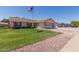 A single-Gathering home boasts a well-manicured front lawn and an attached two-car garage at 2003 W Tyson St, Chandler, AZ 85224