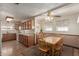 Open kitchen and dining area featuring wood cabinets, linoleum floors and multiple windows at 2003 W Tyson St, Chandler, AZ 85224