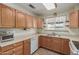 Traditional kitchen with wood cabinets, laminate countertops, and modern appliances at 2003 W Tyson St, Chandler, AZ 85224