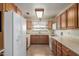 Clean kitchen with wood cabinets, linoleum floors, and plenty of counter space at 2003 W Tyson St, Chandler, AZ 85224
