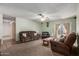 Cozy living room featuring comfortable leather furniture, ceiling fan and access to the back yard at 2003 W Tyson St, Chandler, AZ 85224