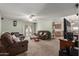 Spacious living room with comfortable brown leather furniture, ceiling fan and back yard access at 2003 W Tyson St, Chandler, AZ 85224