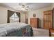 Cozy bedroom with ceiling fan, carpet, wooden doors, and lots of sunlight through the window at 2003 W Tyson St, Chandler, AZ 85224