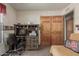 Home office space with a wooden desk, hutch and storage, next to closet with wooden doors at 2003 W Tyson St, Chandler, AZ 85224