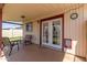 Relaxing covered patio with seating area, ceiling fan and door leading to the outdoors at 2003 W Tyson St, Chandler, AZ 85224