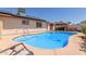 Sparkling backyard pool with a cozy gazebo, set against the backdrop of a charming home at 2003 W Tyson St, Chandler, AZ 85224