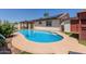 Inviting backyard pool area with nearby covered patio and solar panels on the house at 2003 W Tyson St, Chandler, AZ 85224