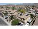 Expansive aerial view of a well-maintained community with mountain views and houses equipped with solar panels at 22022 W Moonlight Path, Buckeye, AZ 85326