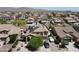 Aerial view of a home with solar panels, a well-manicured yard, and a paved driveway in a residential neighborhood at 22022 W Moonlight Path, Buckeye, AZ 85326