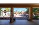 Backyard view from covered patio, features brick-paved open space, decorative plants and outdoor decor at 22022 W Moonlight Path, Buckeye, AZ 85326