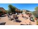 Extensive backyard space featuring various seating areas, desert landscaping, and a shed at 22022 W Moonlight Path, Buckeye, AZ 85326