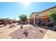 Spacious backyard offering multiple seating areas, desert landscaping, a fire pit, and covered patio at 22022 W Moonlight Path, Buckeye, AZ 85326