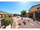 Beautifully landscaped backyard featuring desert landscaping, a fire pit, and covered patio at 22022 W Moonlight Path, Buckeye, AZ 85326