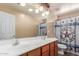 Bathroom with double vanity, large mirror, and western themed shower curtain at 22022 W Moonlight Path, Buckeye, AZ 85326