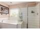 Bathroom features a soaking tub and separate glass enclosed shower at 22022 W Moonlight Path, Buckeye, AZ 85326
