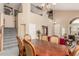 Grand dining room featuring stairs to second story, chandelier, and elegant wood furniture at 22022 W Moonlight Path, Buckeye, AZ 85326