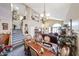 Bright dining area featuring a large dining table, chandelier, and staircase to loft at 22022 W Moonlight Path, Buckeye, AZ 85326