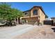 Two-story home with a two-car garage and a paved driveway, complemented by desert landscaping at 22022 W Moonlight Path, Buckeye, AZ 85326