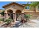 Charming home featuring a stone-accented entryway, desert landscaping, and a welcoming front porch at 22022 W Moonlight Path, Buckeye, AZ 85326