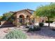 Lovely two-story home with a front yard featuring desert landscaping and mature trees at 22022 W Moonlight Path, Buckeye, AZ 85326