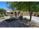 Charming home featuring a well-manicured front yard, desert landscaping, and a decorative windmill at 22022 W Moonlight Path, Buckeye, AZ 85326