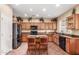 Functional kitchen featuring black appliances, ample cabinetry, a central island with seating, and natural light at 22022 W Moonlight Path, Buckeye, AZ 85326