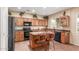 Well-equipped kitchen with granite countertops, black appliances, a convenient island, and a bright window at 22022 W Moonlight Path, Buckeye, AZ 85326