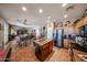 Open kitchen view featuring wood cabinets, island, stainless steel appliances, and decor accents at 22022 W Moonlight Path, Buckeye, AZ 85326