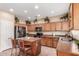 Kitchen featuring wooden cabinets, granite countertops, stainless steel appliances, and a spacious island with seating at 22022 W Moonlight Path, Buckeye, AZ 85326