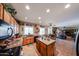 Spacious kitchen featuring wood cabinets, an island, granite counters and decor accents at 22022 W Moonlight Path, Buckeye, AZ 85326
