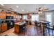 Large open kitchen with an island, dark appliances, and casual dining area at 22022 W Moonlight Path, Buckeye, AZ 85326
