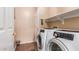 Laundry room equipped with modern, front loading, Samsung washer and dryer at 22022 W Moonlight Path, Buckeye, AZ 85326