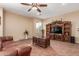 Comfortable living room featuring a wooden entertainment center and a decorative ceiling fan at 22022 W Moonlight Path, Buckeye, AZ 85326