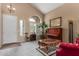 Cozy living room with vaulted ceiling, ample natural light, and a piano, creating a welcoming atmosphere at 22022 W Moonlight Path, Buckeye, AZ 85326
