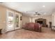 Expansive living area with French doors to patio, unique tile flooring, and a ceiling fan at 22022 W Moonlight Path, Buckeye, AZ 85326