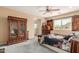 Cozy main bedroom featuring carpet, a ceiling fan, and an ensuite bathroom at 22022 W Moonlight Path, Buckeye, AZ 85326
