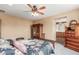 Bright main bedroom showing off carpet, a ceiling fan, and an ensuite bathroom at 22022 W Moonlight Path, Buckeye, AZ 85326