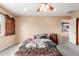 Inviting bedroom with barn door accent, carpet, and view into ensuite bathroom at 22022 W Moonlight Path, Buckeye, AZ 85326