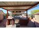Outdoor kitchen featuring stainless steel grill, countertop, and outdoor decor with covered awning at 22022 W Moonlight Path, Buckeye, AZ 85326