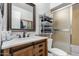 Bathroom featuring modern vanity, brushed nickel fixtures, and a glass shower at 2207 N 53Rd Ave, Phoenix, AZ 85035