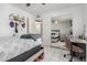 Comfortable bedroom with a desk area and sliding mirror door closet at 2207 N 53Rd Ave, Phoenix, AZ 85035