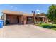 Exterior of home with a long driveway, covered parking, and inviting front porch at 2207 N 53Rd Ave, Phoenix, AZ 85035