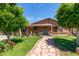 Charming home featuring a stone walkway and well-manicured lawn with mature trees at 2207 N 53Rd Ave, Phoenix, AZ 85035