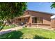 Charming home featuring a well-maintained front yard with paved walkway and lush greenery at 2207 N 53Rd Ave, Phoenix, AZ 85035