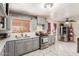 Well-lit kitchen with stainless steel appliances, grey cabinets, and tile flooring at 2207 N 53Rd Ave, Phoenix, AZ 85035